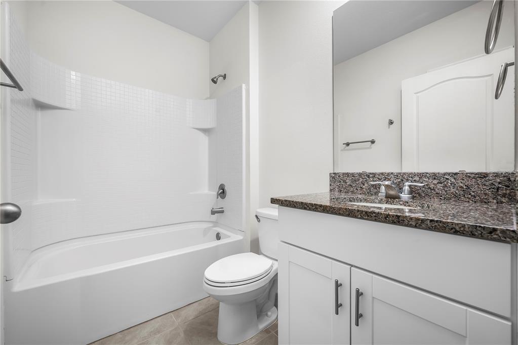 114 Birch Tree Place Daytona Beach, FL 32117 - Photo 24 of 33 a bathroom with a granite countertop bathtub shower sink vanity and toilet