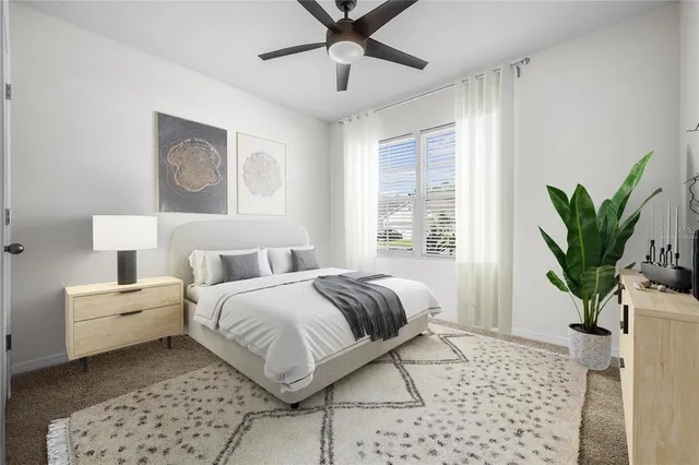 a bedroom with a bed and a potted plant