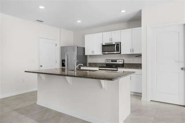 a kitchen with stainless steel appliances a sink stove and refrigerator