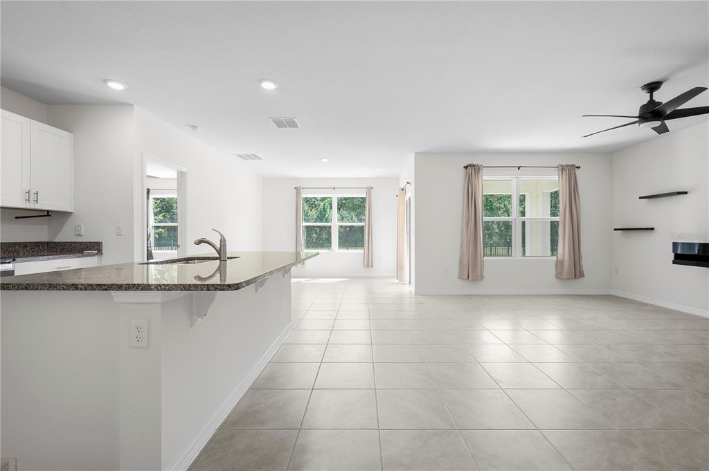 114 Birch Tree Place Daytona Beach, FL 32117 - Photo 8 of 33 a large kitchen with kitchen island a window in it