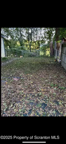 a view of kitchen with granite countertop cabinets and black appliances