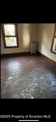 a view of a big room with wooden floor