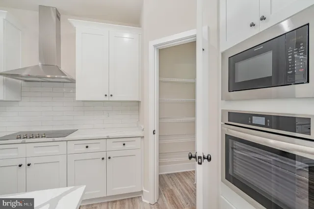 a view of a room with wooden floor