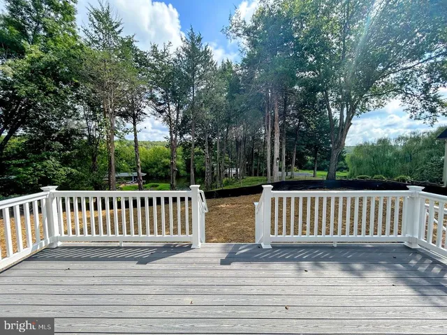 a view of a deck with a chair and wooden floor