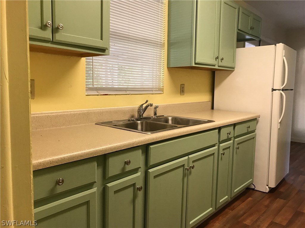 12631 Fourth Street Fort Myers, FL 33905 - Photo 3 of 16 a kitchen with a sink and refrigerator