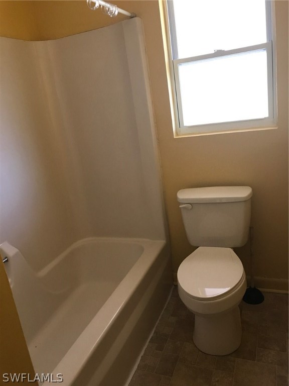12631 Fourth Street Fort Myers, FL 33905 - Photo 10 of 16 a white toilet sitting next to a bath tub