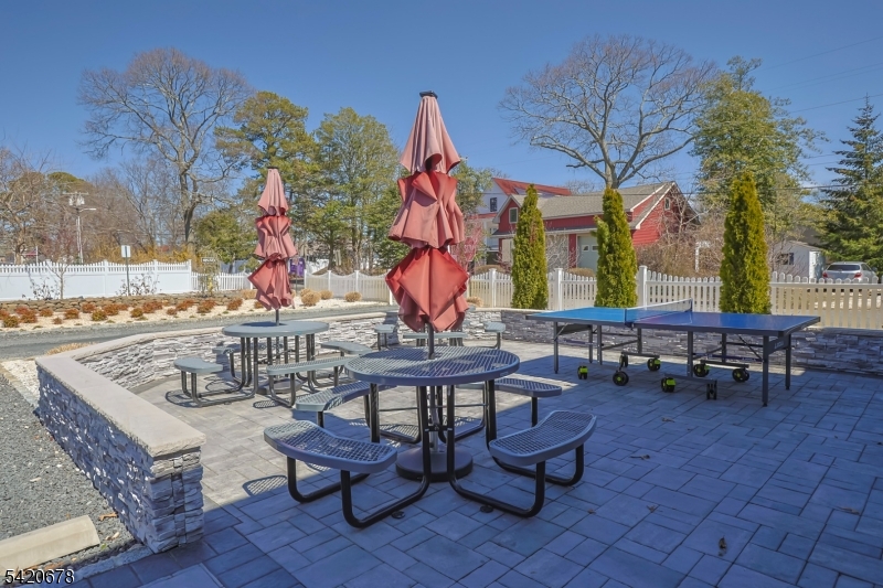 246 Mantoloking Road, Unit 3 Brick, NJ 08723 - Photo 12 of 12 a view of a dinning tables and chairs in the patio