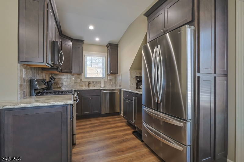 246 Mantoloking Road, Unit 3 Brick, NJ 08723 - Photo 5 of 12 a kitchen with stainless steel appliances granite countertop a refrigerator and a sink