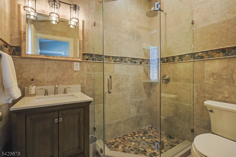 246 Mantoloking Road, Unit 3 Brick, NJ 08723 - Photo 7 of 12 a bathroom with a sink toilet and shower