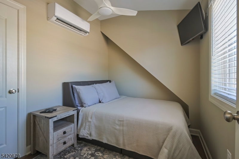 246 Mantoloking Road, Unit 3 Brick, NJ 08723 - Photo 8 of 12 a bed room with a bed and a television