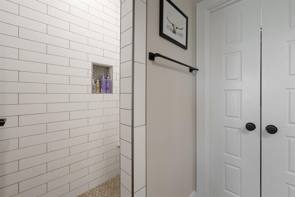 1031 Augustus Court Rio Vista, TX 76093 - Photo 12 of 30 Shower with white subway tile surround, honeycomb tile floor, and built-in niche