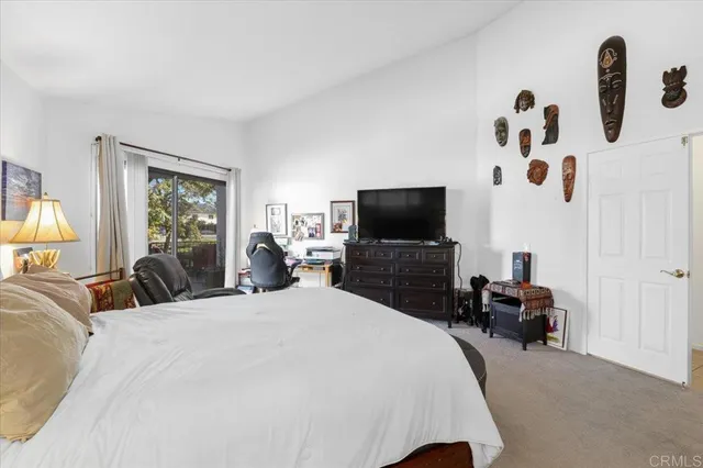 a bedroom with bed tv and a fireplace
