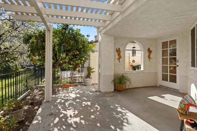 a porch with a table and chairs