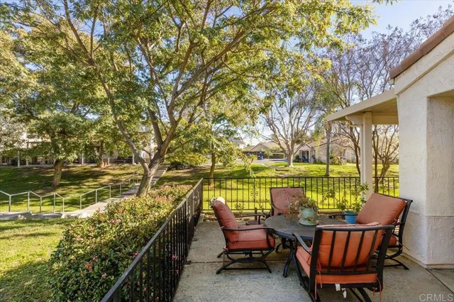 a front view of a house with a garden and yard