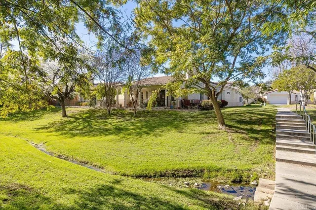 a swimming pool with trees in the background