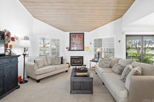 a living room with furniture large window and fireplace