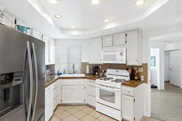 a kitchen with a refrigerator stove and sink