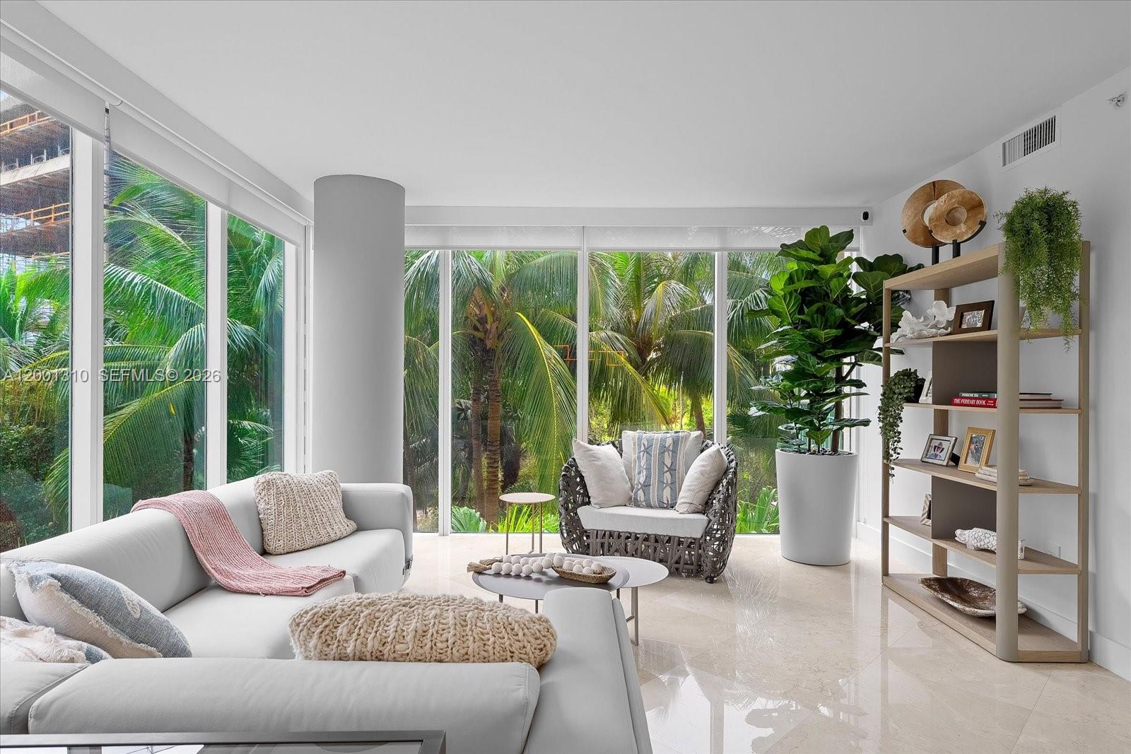 3400 Southwest 27th Avenue, Unit 201 Miami, FL 33133 - Photo 5 of 10 a living room with furniture and a large window