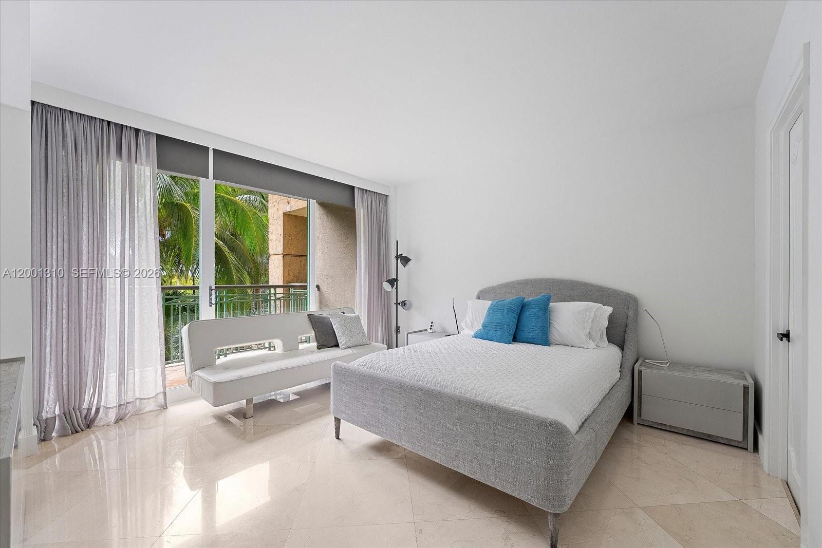 3400 Southwest 27th Avenue, Unit 201 Miami, FL 33133 - Photo 9 of 10 a bedroom with a bed and a large window
