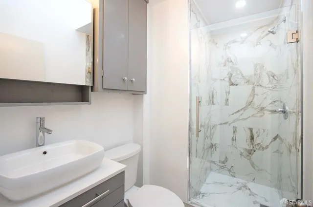 a bathroom with a sink toilet and shower