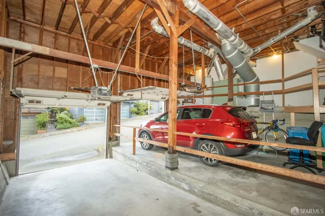 a view of a red car is parked in front of a building