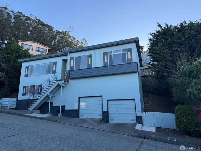 a house that has a tree in front of it