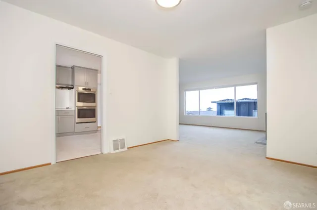 an empty room with an empty space and windows