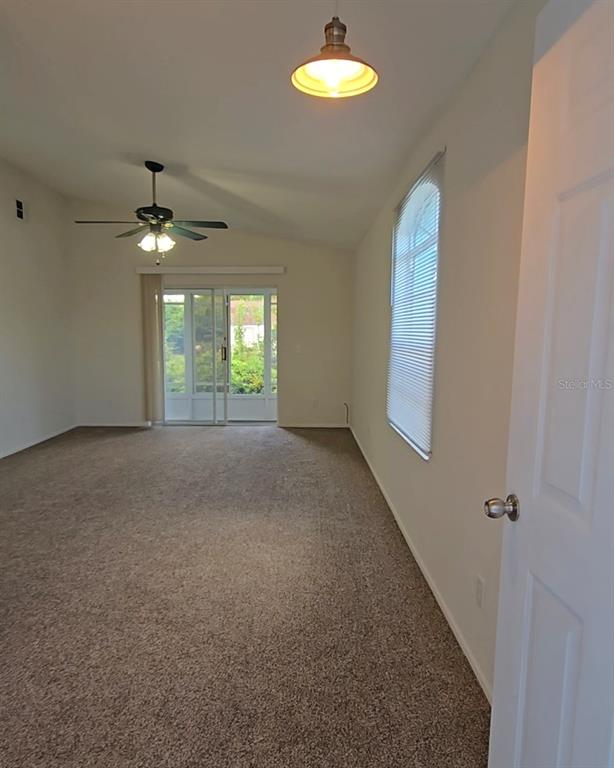 4225 San Rafael Avenue New Port Richey, FL 34655 - Photo 5 of 20 wooden floor in an empty room with a window
