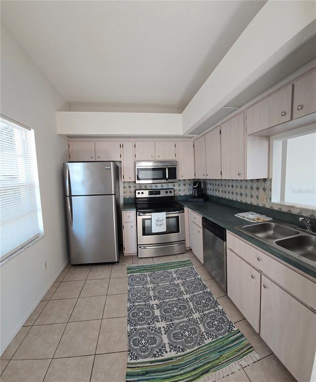 4225 San Rafael Avenue New Port Richey, FL 34655 - Photo 8 of 20 a kitchen with stainless steel appliances granite countertop a refrigerator stove top oven and sink