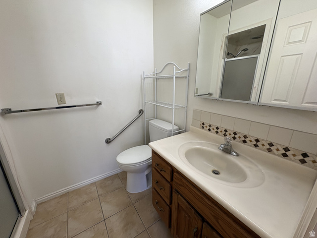 486 West 120 North Orem, UT 84057 - Photo 12 of 30 Bathroom featuring a wood-finish vanity with an integrated sink and a neutral countertop