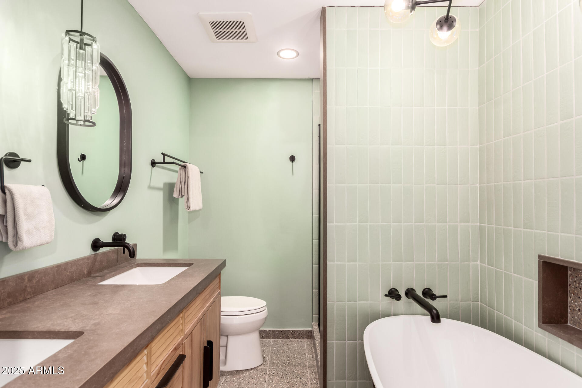 6022 North 10th Way Phoenix, AZ 85014 - Photo 29 of 40 a bathroom with a sink a toilet and a mirror