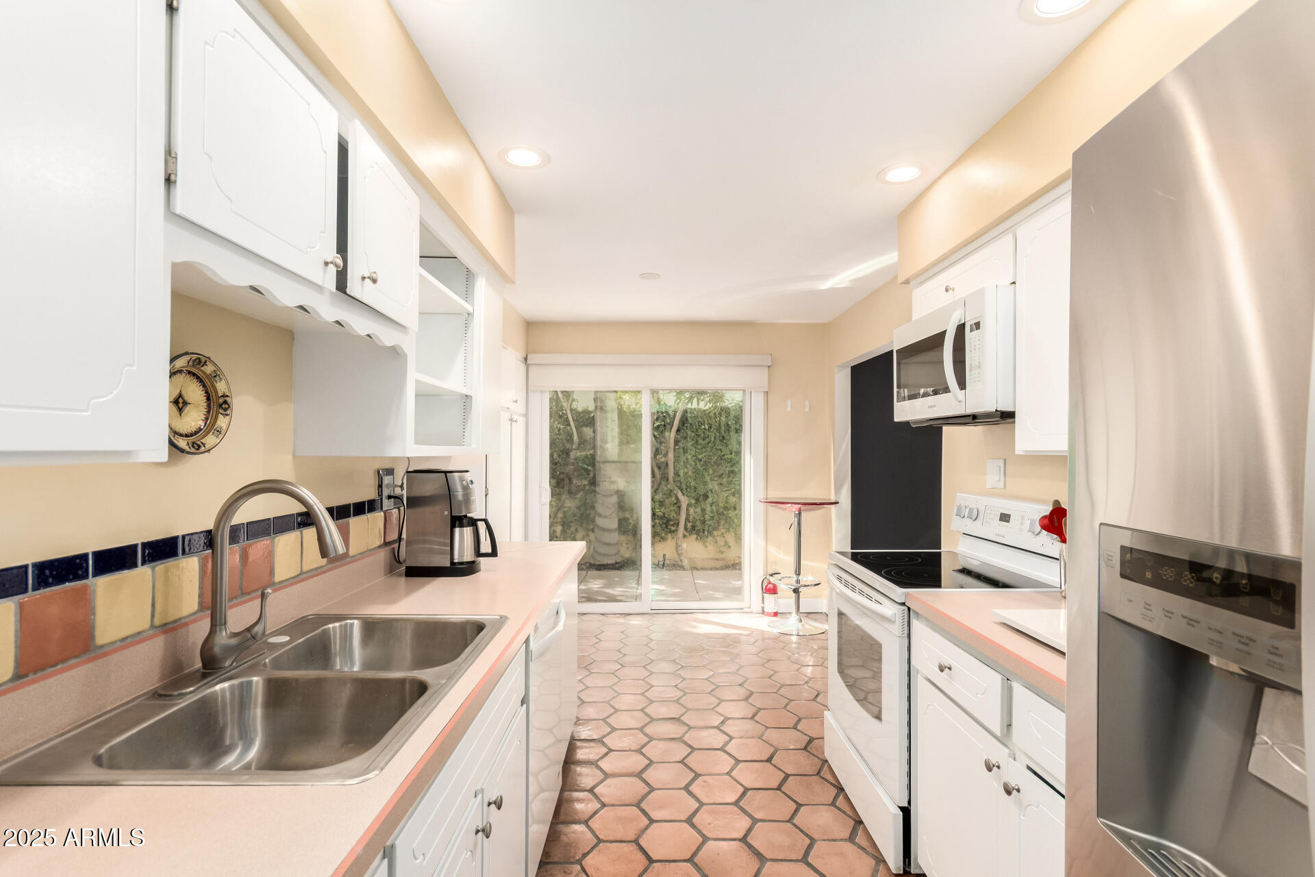 6022 North 10th Way Phoenix, AZ 85014 - Photo 7 of 40 a kitchen with granite countertop a sink a counter top space appliances and cabinets
