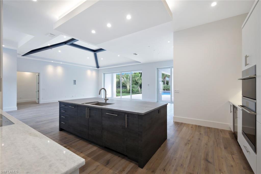 16743 Enclave Circle Naples, FL 34110 - Photo 11 of 42 a view with cabinets and wooden floor