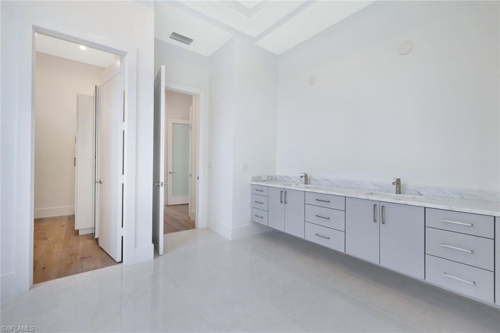 16743 Enclave Circle Naples, FL 34110 - Photo 16 of 42 a large white cabinet