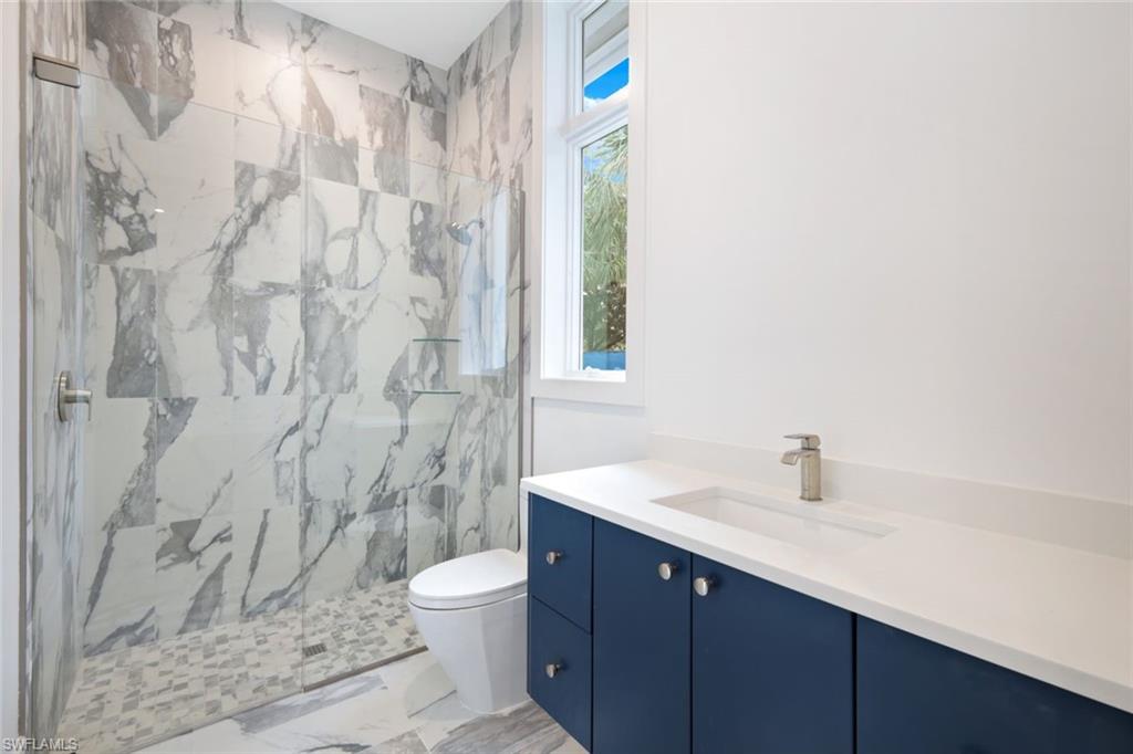 16743 Enclave Circle Naples, FL 34110 - Photo 21 of 42 a bathroom with a sink a toilet and shower curtain