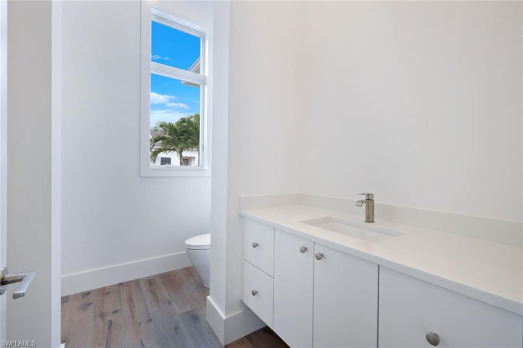 16743 Enclave Circle Naples, FL 34110 - Photo 23 of 42 a view of a bathroom with sink and wooden floor