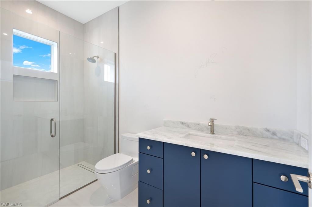 16743 Enclave Circle Naples, FL 34110 - Photo 25 of 42 a bathroom with a sink a toilet and shower