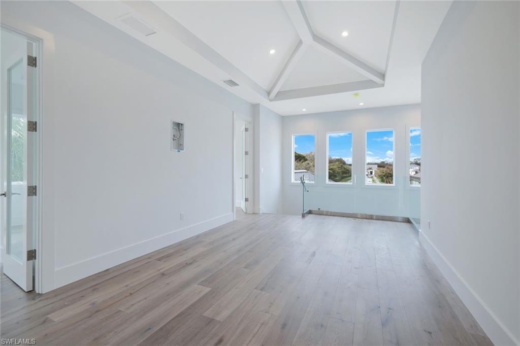 16743 Enclave Circle Naples, FL 34110 - Photo 26 of 42 wooden floor in an empty room with a window
