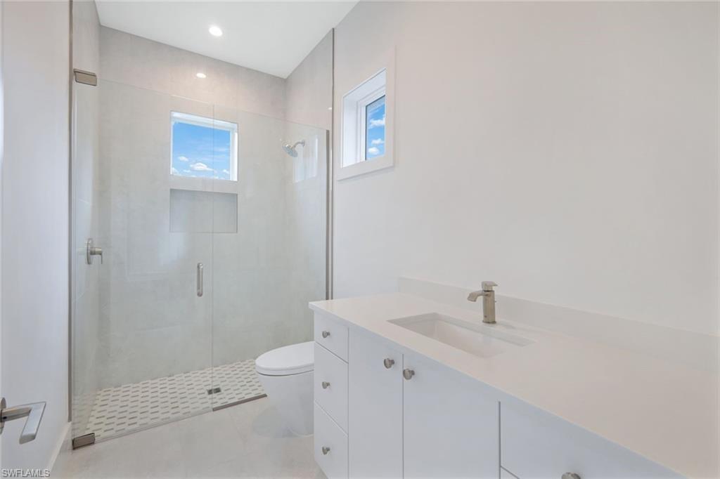 16743 Enclave Circle Naples, FL 34110 - Photo 27 of 42 a bathroom with a sink a toilet and shower