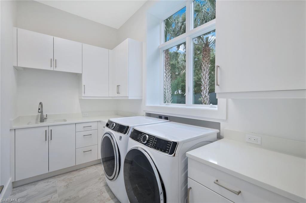 16743 Enclave Circle Naples, FL 34110 - Photo 28 of 42 a utility room with dryer and washer