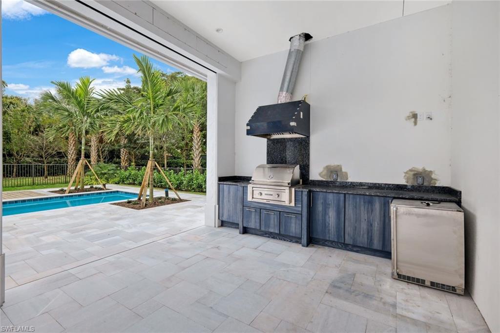 16743 Enclave Circle Naples, FL 34110 - Photo 29 of 42 a view of a room with gym equipment and floor to ceiling window