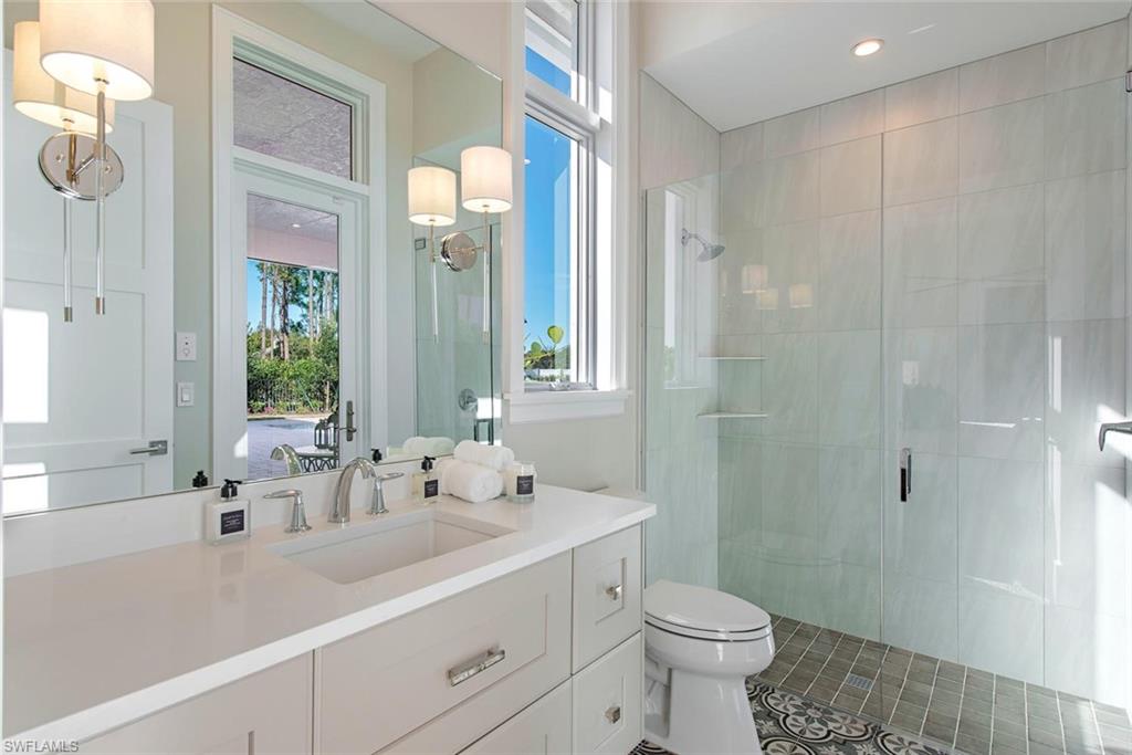 16743 Enclave Circle Naples, FL 34110 - Photo 30 of 42 a bathroom with a sink a toilet and shower