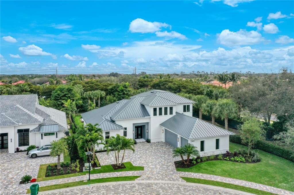 16743 Enclave Circle Naples, FL 34110 - Photo 3 of 42 a front view of a house with a yard and garage