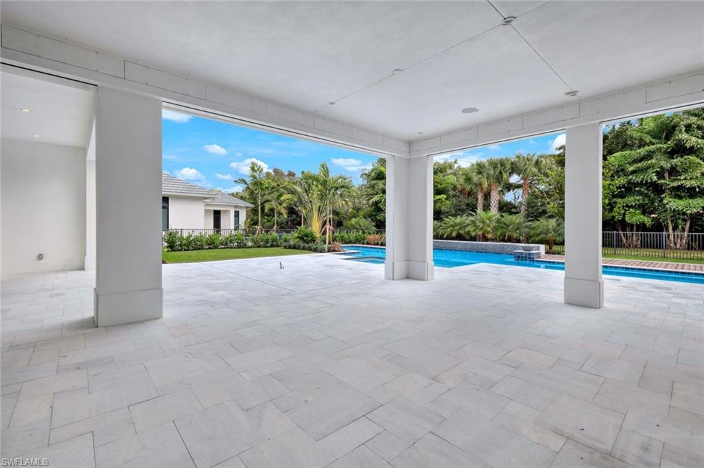 16743 Enclave Circle Naples, FL 34110 - Photo 31 of 42 a view of a house with porch and garden