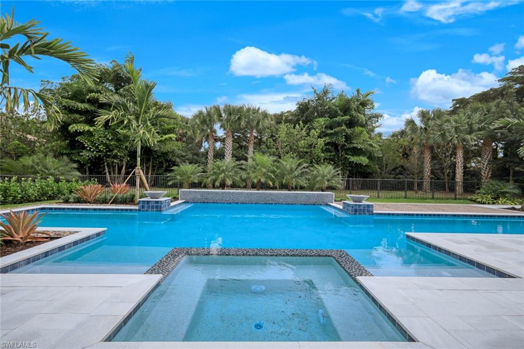 16743 Enclave Circle Naples, FL 34110 - Photo 32 of 42 a view of a swimming pool with an outdoor space and seating area