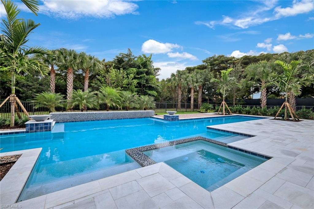 16743 Enclave Circle Naples, FL 34110 - Photo 34 of 42 a view of a swimming pool with a patio