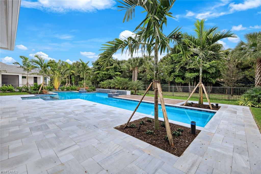 16743 Enclave Circle Naples, FL 34110 - Photo 35 of 42 a small garden with trees in the background