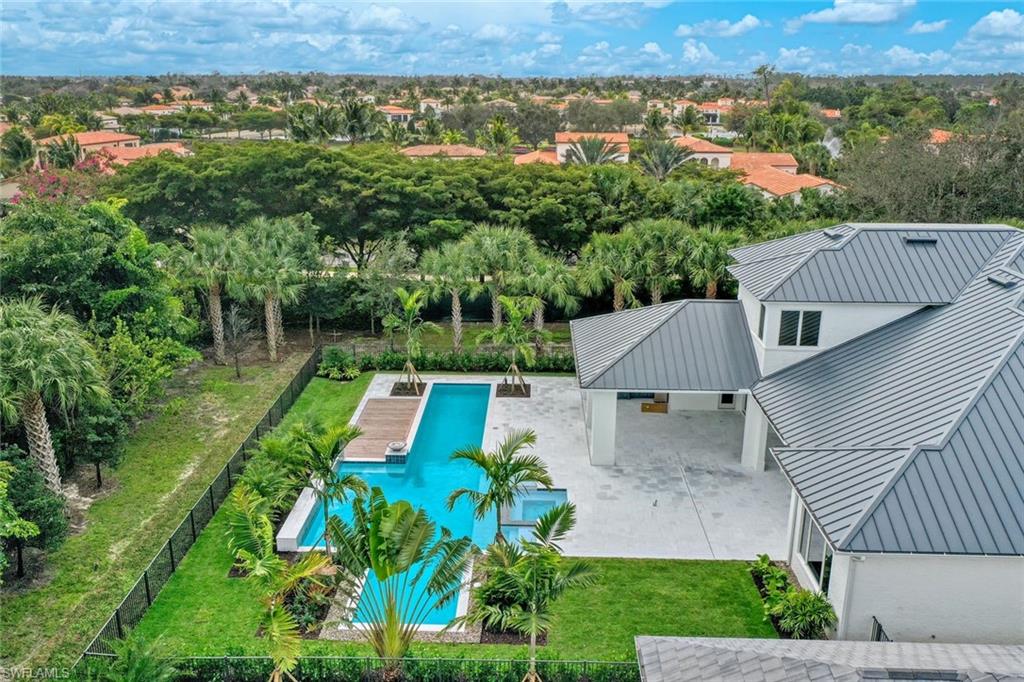 16743 Enclave Circle Naples, FL 34110 - Photo 40 of 42 an aerial view of a house with a garden and lake view