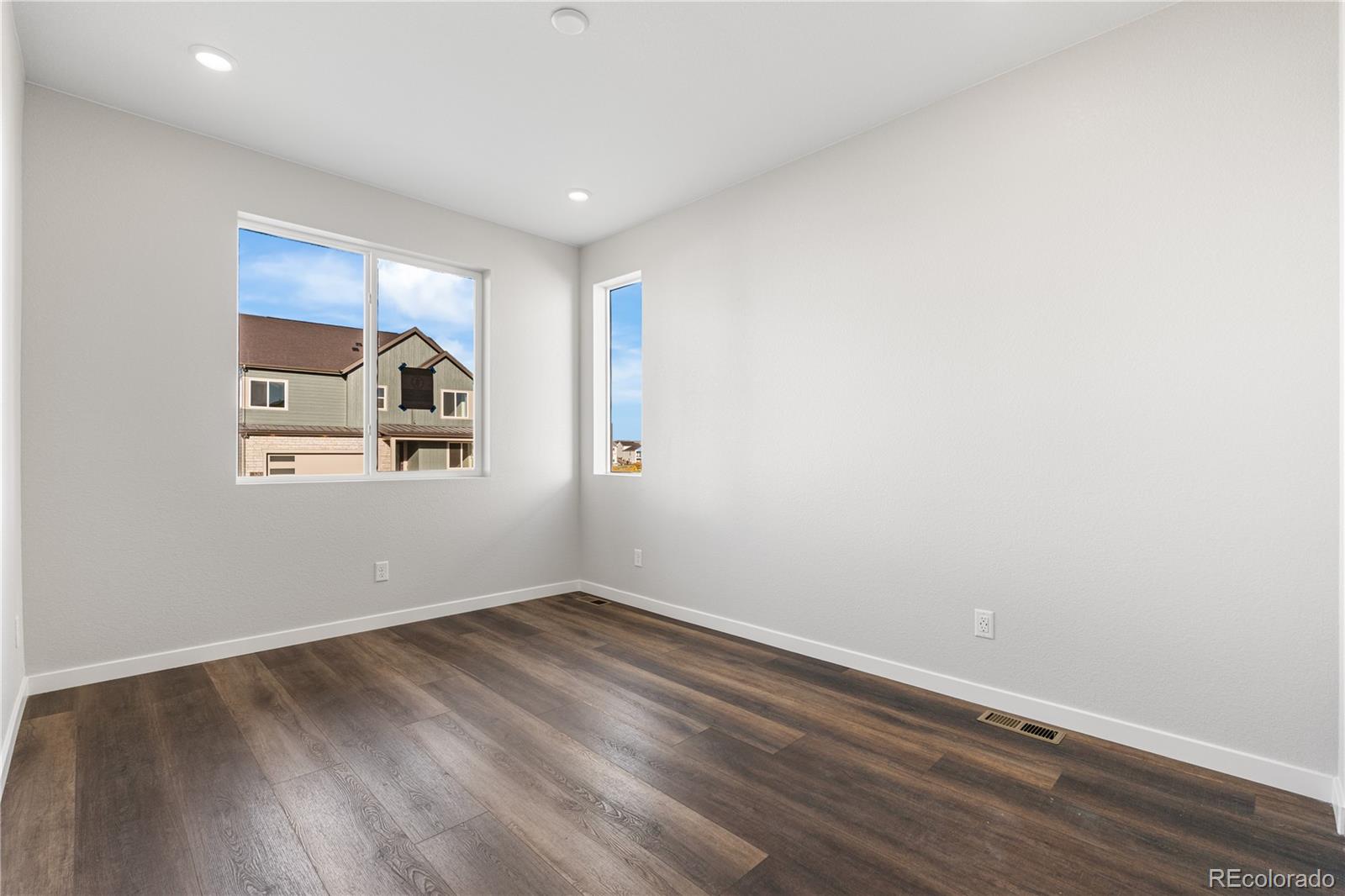 1250 Bridgefield Road Castle Pines, CO 80108 - Photo 17 of 33 a view of a room with wooden floor and white walls