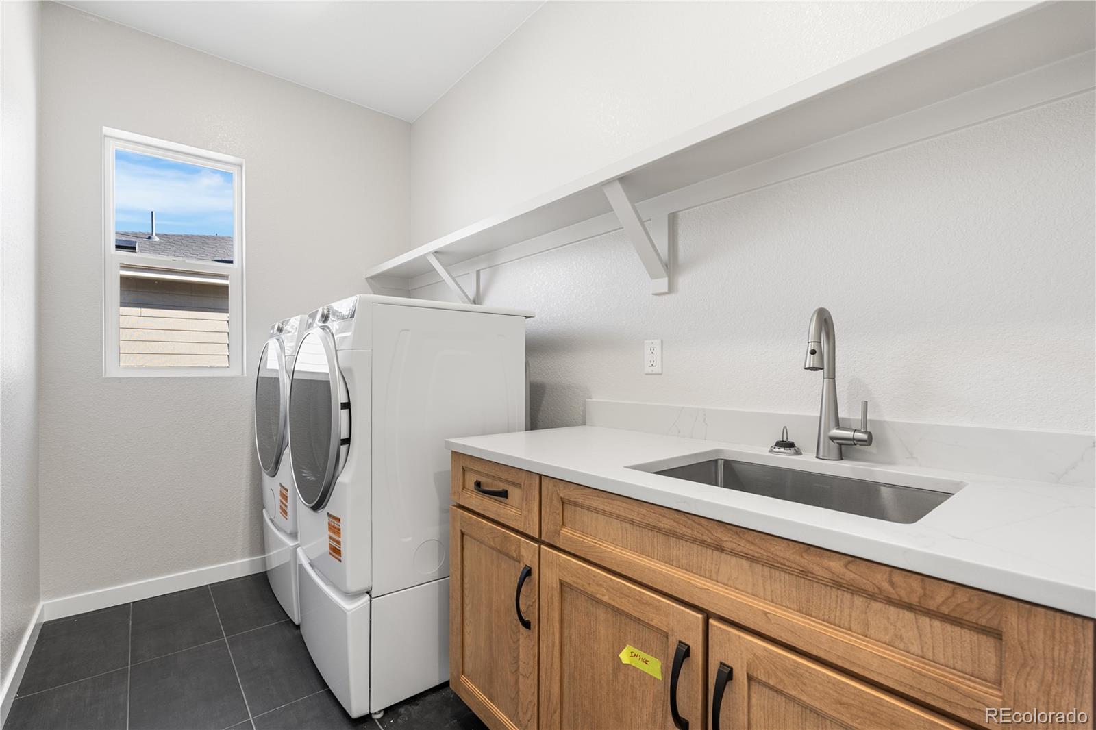 1250 Bridgefield Road Castle Pines, CO 80108 - Photo 20 of 33 a utility room with dryer and washer